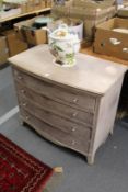 A limed wood four drawer chest.