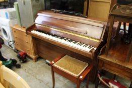 A Bentley upright piano with piano stool.