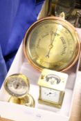 A copper and brass barometer, a desk barometer and a carriage clock.