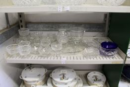 A shelf of cut glass sundae dishes and other items.
