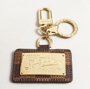 A LOUIS VITTON PATTERN KEY RING in a box.