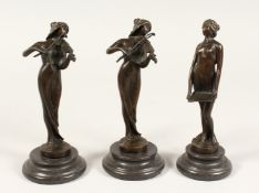A SET OF THREE ART NOUVEAU BRONZE FEMALE MUSICIANS on a circular base. 7.5ins high
