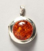 A SILVER AND AMBER LOCKET