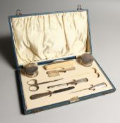 A SILVER MOUNTED MANICURE SET IN BOX. Birmingham 1902
