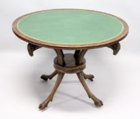 A REGENCY MAHOGANY CIRCULAR TABLE, with inset leather top with four curving rams masks on hoof feet.