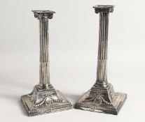 A GOOD PAIR OF GEORGE III SILVER CLASSICAL CANDLESTICKS with Corinthian columns, square loaded bases