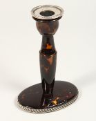 A TORTOISESHELL SILVER MOUNTED CANDLESTICK 5ins high.