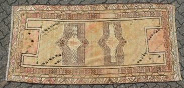 AN UNUSUAL PERSIAN HALL CARPET, beige ground, two central lozenge shaped medallions with stylised