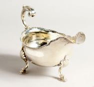 A GEORGE III SILVER SAUCEBOAT on three pad feet. London 1773, maker T. E.