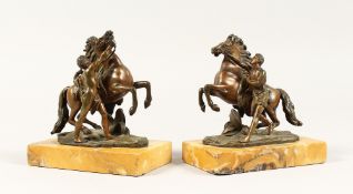 A SMALL PAIR OF ITALIAN BRONZE MARLEY HORRSES AND ATTENDANTS on marble base. 6ins high