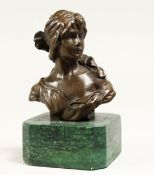 A SMALL FEMALE BUST 4.5ins high on a marble base.