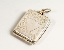 AN ENGRAVED SILVER STAMP HOLDER.