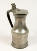 A NORMANDY PEWTER LIDDED JUG 9ins high.