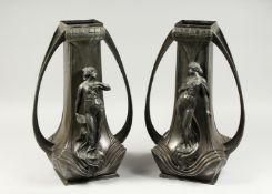 A LARGE PAIR OF ART NOUVEAU PEWTER TWO HANDLED VASES, the sides with classical female figures in