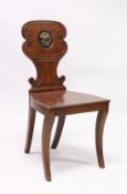 A GEORGE III MAHOGANY HALL CHAIR with solid seat, the shaped back with a painted crest.