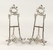 A PAIR OF MEDIUM SILVERED EASELS 1ft 4ins high
