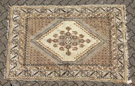 A PERSIAN RUG brown and cream with large medallions. 6ft 6ins long x 4ft 6ins wide