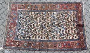 A GOOD PERSIAN RUG, the central beige ground with all over stylised animal motifs. 7ft 8ins x 4ft