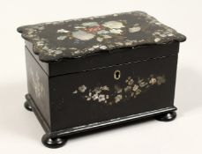 A GOOD VICTORIAN BLACK PAPIER MACHE TWO DIVISION TEA CADDY inlaid with mother of pearl on bun