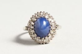 A GOLD CARBOUCHON SAPPHIRE AND DIAMOND RING
