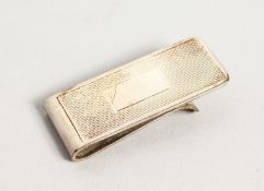 AN ENGINE TURNED SILVER MONEY CLIP.