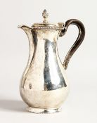 A VICTORIAN SILVER HOT WATER JUG with leather handle. Sheffield 1877, maker C.F. Weighs 13ozs.