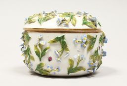 A DRESDON CIRCULAR BOWL AND COVER painted with moths and encrusted with flowers. 4.5ins diameter.