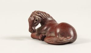 A JAPANESE CARVED WOOD HORSE NETSUKE Signed