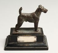 A FOX TERRIER with silver tablet. 2.5ins long