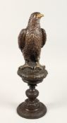 A GOOD BRONZE EAGLE on a pedestal. 16ins high.