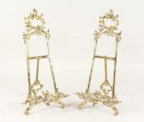 A PAIR OF LARGE BRASS EASELS 1ft 8ins high.