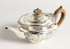 A VICTORIAN CIRCULAR SILVER TEA POT with gadrooned edge and repousse decoration. London 1896,