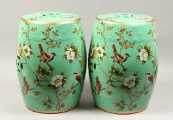 A PAIR OF CHINESE GREEN FLORAL DECORATED SEATS 18ins high.