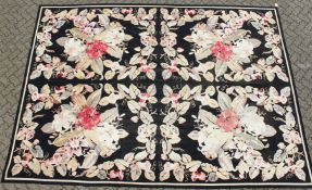 A LARGE ABUSSON STYLE TAPESTRY WALL HANGING, black ground, with floral decoration. 14ft 2ins x