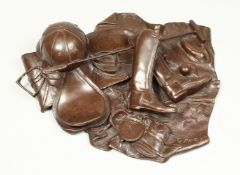 G.P.K. A BRONZE GROUP- HAT, BOOTS, POLO STICK ETC., monogrammed G.P.K. 86. 12ins across.