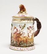 A CAPODIMONTE PORCELAIN TANKARD AND COVER, classical scene in relief. Blue N mark. 7ins high.