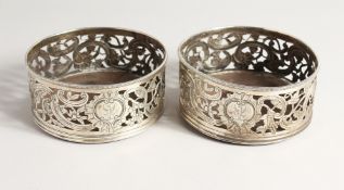 A GOOD PAIR OF GEORGE III IRISH SILVER WINE COASTERS with plain wooden bases, the silver sides