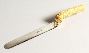 A SILVER LETTER OPENER with carved bone Chinese handles. 10 ins long, London 1804.