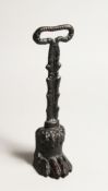 A CAST IRON CLAW DOOR STOP 13.5ins high.