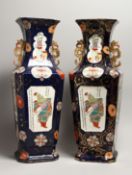 A LARGE PAIR OF IRONSTONE JAPAN PATTERN TWO HANDLED VASES with Chinese panels. 23ins high.