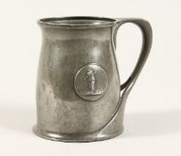A TUDRIC ARCHIBALD KNOX PEWTER TANKARD with an oval of a golfer No. 066 4.25ins high.