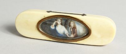 A GEORGIAN IVORY LONG PINBOX, the top with an oval, lady and young boy. 4ins long.