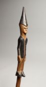A SOUTH AFRICAN WOODEN STAFF with elongated figures 39ins long