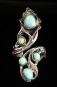 AN ART NOUVEAU DESIGN SILVER AND RED OPAL RING