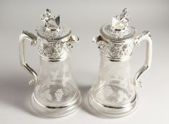 A PAIR OF CLARET JUGS engraved with fruiting vines, with plated mounts
