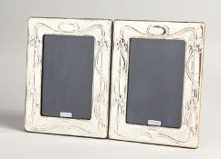 A PAIR OF SILVER ART NOUVEAU DESING PHOTOGRAPH FRAMES 7.5ins x 5.5ins