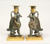 A PAIR OF THOMAS HOPE DESIGN GRIFFIN CANDLESTICKS 8.5ins high.