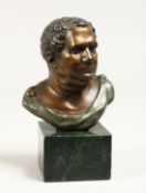 A SMALL ROMAN BUST 4.5ins high on a marble base.