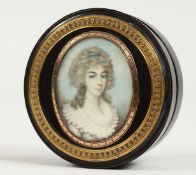 A GEORGIAN EBONY CIRCULAR BOX, the top painted with a portrait of a young lady in a white lace