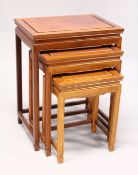 A NEST OF FOUR CHINESE TABLES Largest 1ft 8ins.